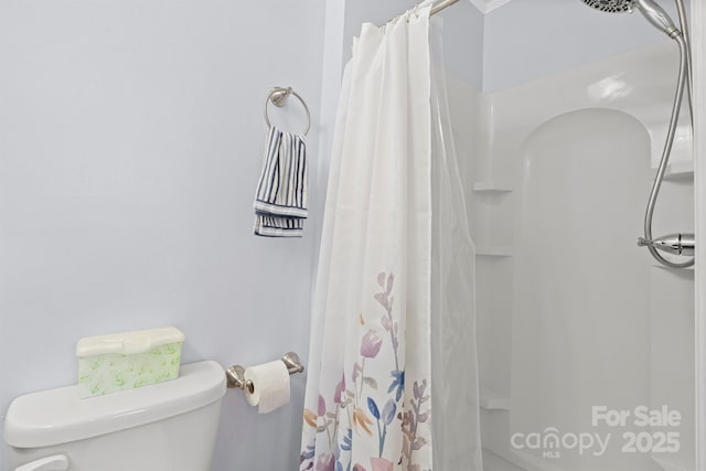 bathroom with a shower with shower curtain and toilet