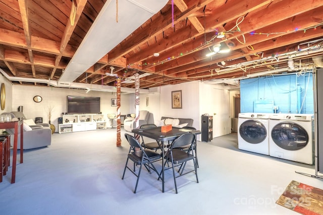 dining space featuring concrete flooring and washer and dryer