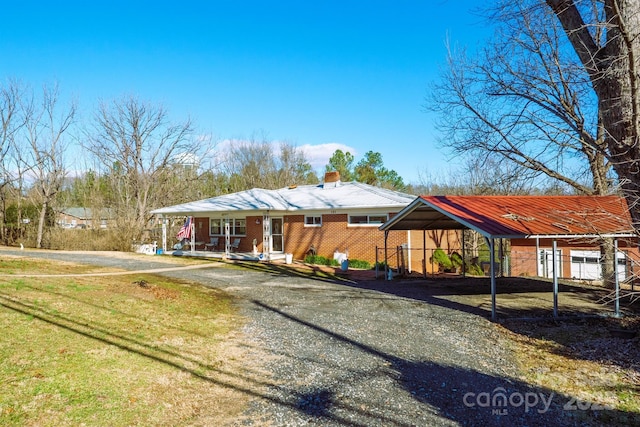 ranch-style home with a carport and covered porch