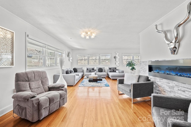 living area featuring a notable chandelier, a textured ceiling, and light wood finished floors