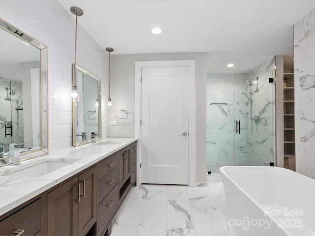 bathroom featuring vanity and independent shower and bath