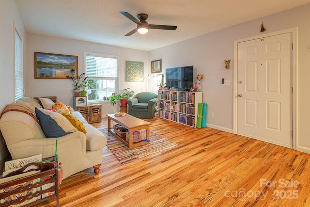 living room with ceiling fan and light hardwood / wood-style floors