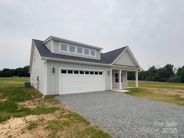 46 Griffin Rd Unit 2, Pageland, SC 29728 - view of front of property featuring driveway, board and batten siding, central air condition unit, a front yard, and a shingled roof
