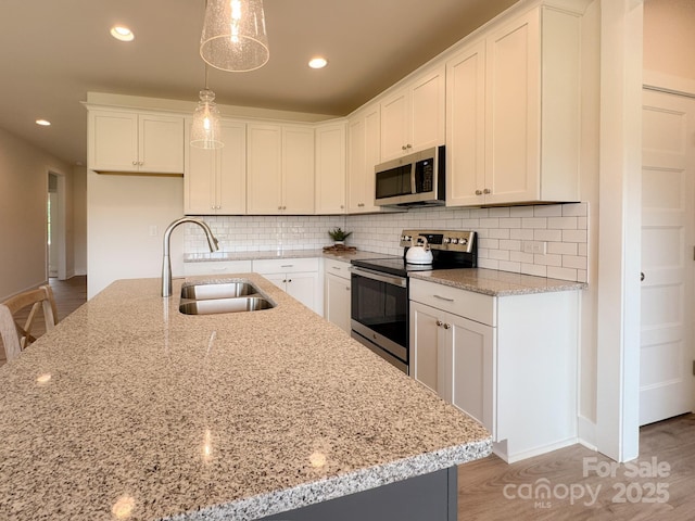 46 Griffin Rd Unit 2, Pageland, SC 29728 - kitchen featuring appliances with stainless steel finishes, a sink, light stone counters, and recessed lighting