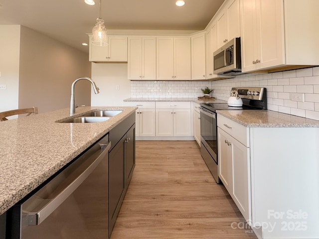46 Griffin Rd Unit 2, Pageland, SC 29728 - kitchen featuring stainless steel appliances, a sink, light stone countertops, white cabinetry, and recessed lighting