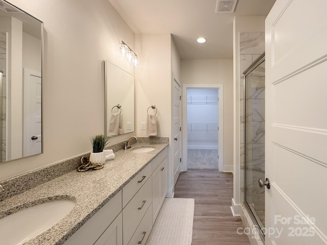46 Griffin Rd Unit 2, Pageland, SC 29728 - full bathroom featuring a shower stall, double vanity, a walk in closet, wood finished floors, and recessed lighting