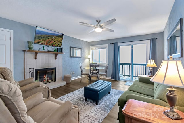 living room with a fireplace, hardwood / wood-style floors, and ceiling fan