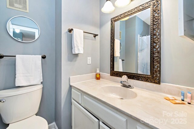 bathroom featuring vanity and toilet