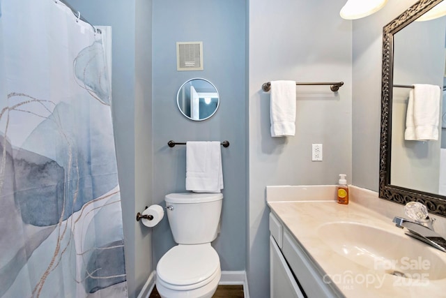 bathroom with vanity, toilet, and walk in shower