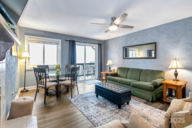 living room with ceiling fan and wood-type flooring