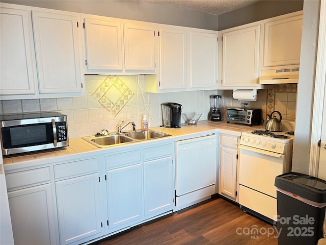 kitchen with ventilation hood, white cabinetry, white appliances, and sink