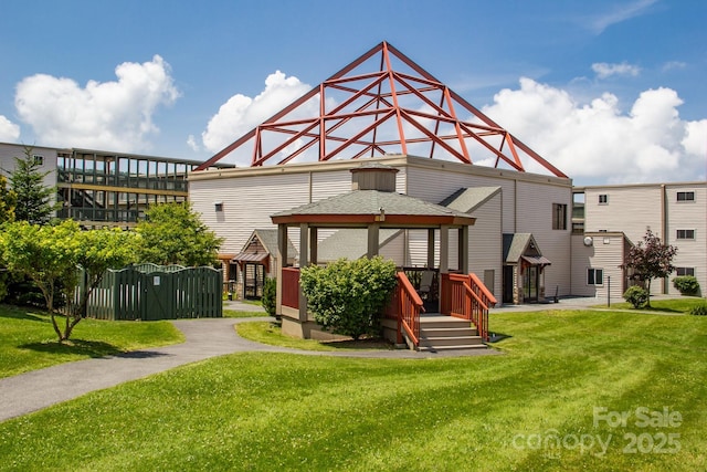 back of house with a gazebo and a yard