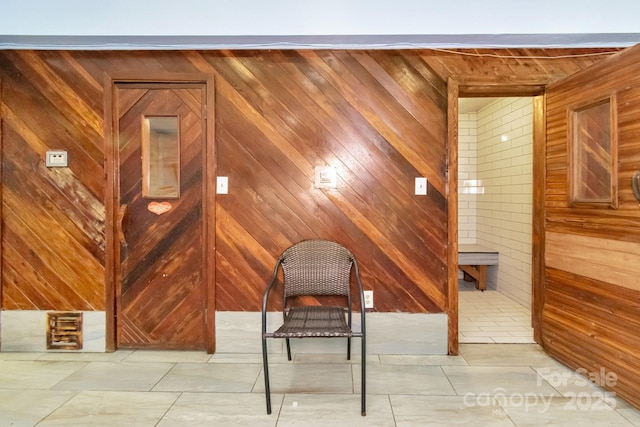 interior space featuring tile patterned floors and wooden walls