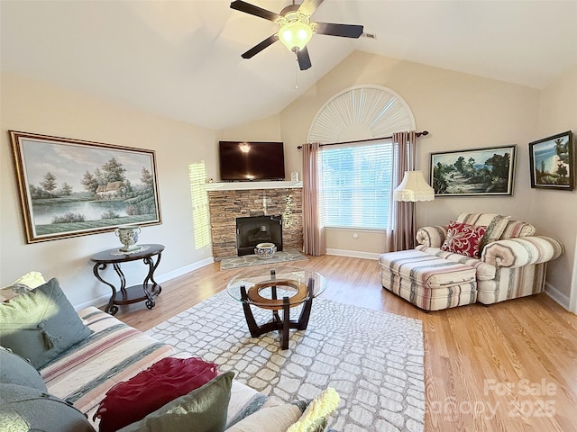 living room with lofted ceiling, ceiling fan, and light hardwood / wood-style floors