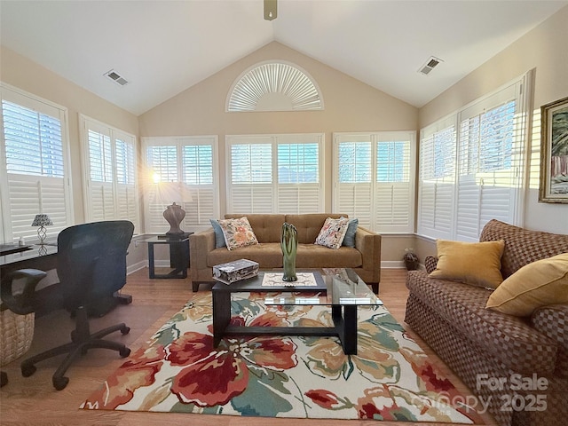 sunroom with a wealth of natural light and lofted ceiling