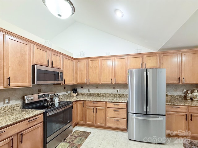 kitchen featuring backsplash, appliances with stainless steel finishes, high vaulted ceiling, light stone counters, and light tile patterned flooring