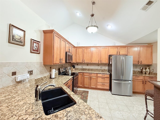 kitchen with stainless steel appliances, light tile patterned floors, pendant lighting, light stone counters, and sink