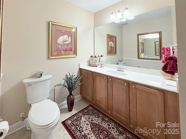 bathroom with vanity, tile patterned floors, and toilet