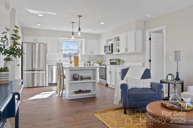 living room with hardwood / wood-style floors and sink