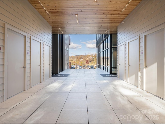 corridor featuring floor to ceiling windows and wood ceiling