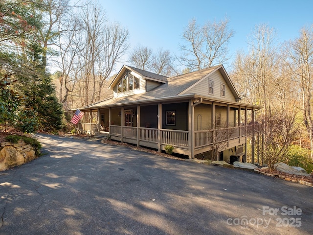 view of side of home with covered porch and a garage