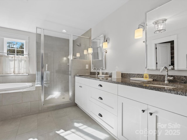 bathroom with shower with separate bathtub, vanity, and tile patterned floors