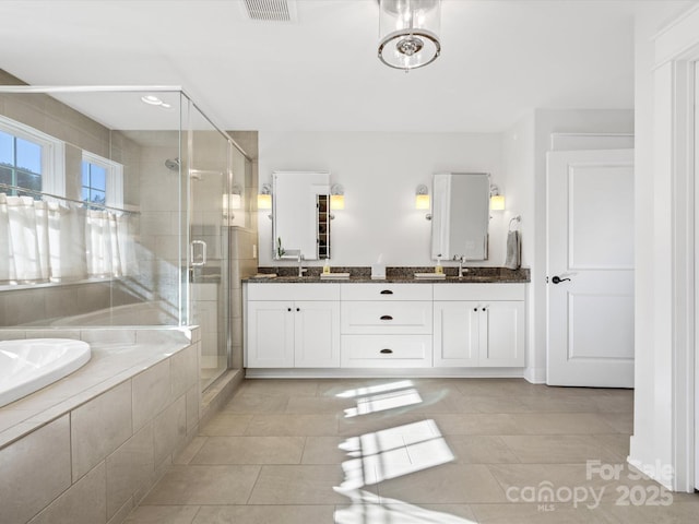 bathroom featuring vanity, tile patterned floors, and separate shower and tub