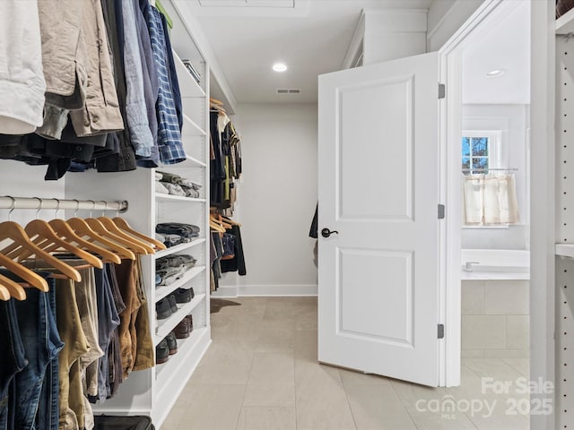 spacious closet featuring light tile patterned flooring