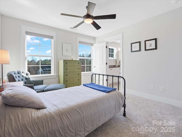 carpeted bedroom with connected bathroom and ceiling fan