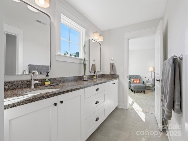 bathroom featuring tile patterned flooring and vanity