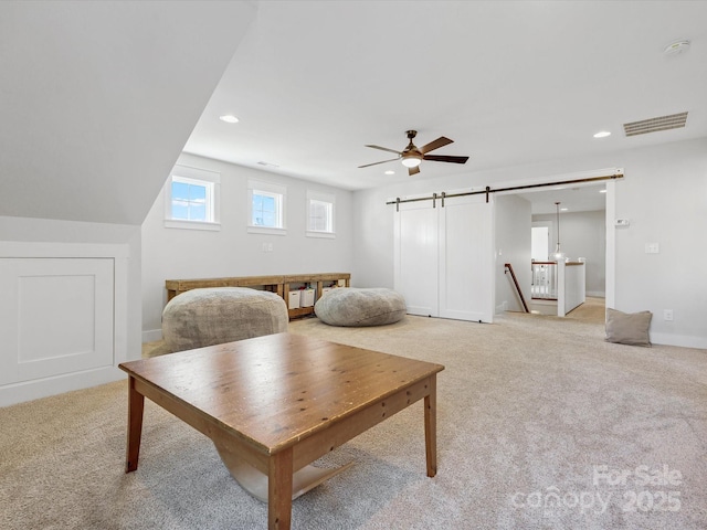 living area with ceiling fan and light colored carpet