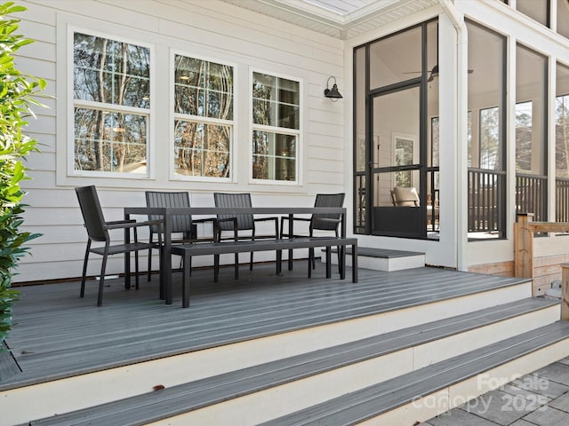 wooden deck featuring a sunroom