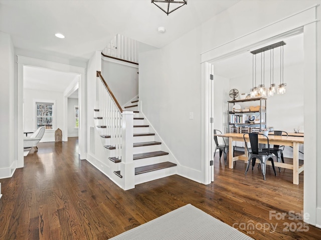 stairway with hardwood / wood-style floors