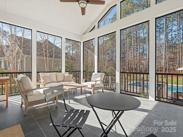 sunroom / solarium featuring ceiling fan and lofted ceiling