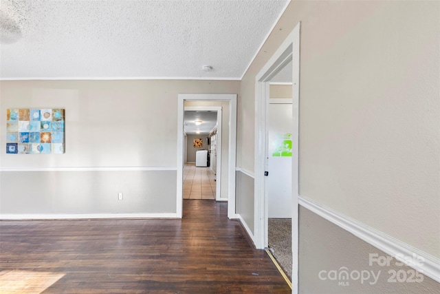 unfurnished room featuring dark hardwood / wood-style flooring and a textured ceiling