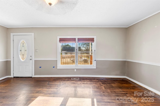 entrance foyer with dark wood-type flooring and a textured ceiling