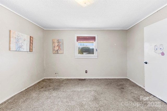 carpeted spare room with a textured ceiling