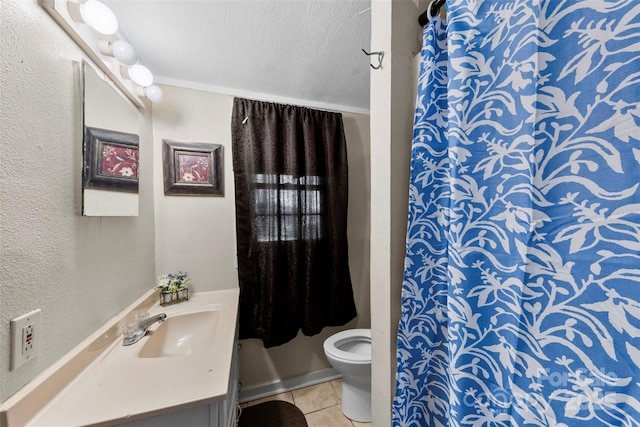 bathroom featuring tile patterned floors, vanity, a textured ceiling, and toilet