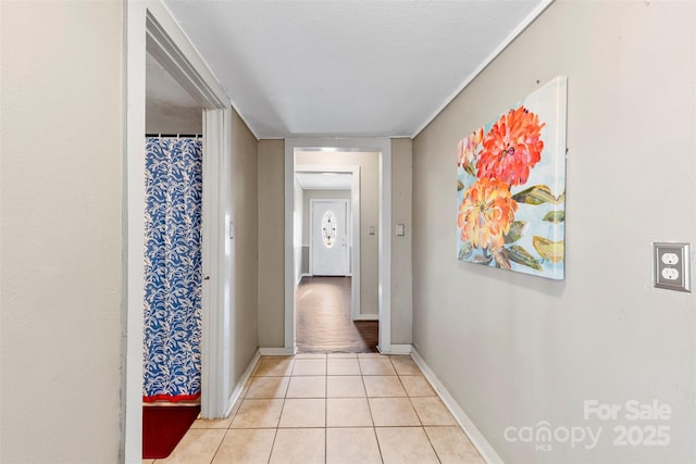 corridor with light tile patterned floors