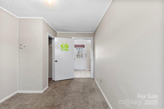 corridor featuring a textured ceiling and light carpet