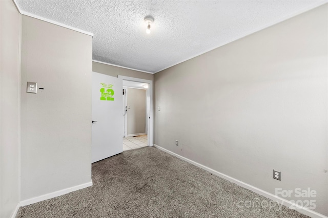 carpeted spare room featuring a textured ceiling