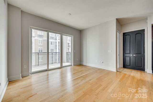 empty room with light hardwood / wood-style flooring