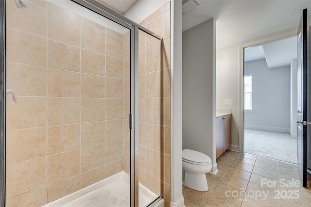 bathroom featuring vanity, an enclosed shower, tile patterned floors, and toilet