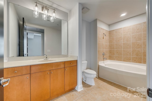 full bathroom with tiled shower / bath, vanity, tile patterned floors, and toilet