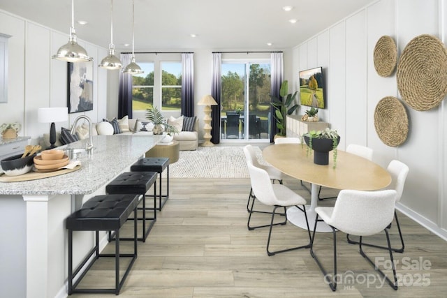 dining area with light hardwood / wood-style flooring