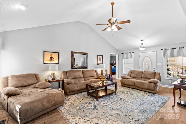 living room featuring lofted ceiling, light hardwood / wood-style floors, and ceiling fan