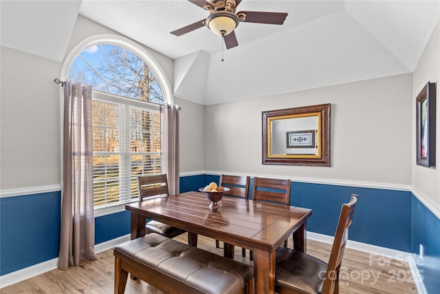 dining area featuring vaulted ceiling, ceiling fan, and light hardwood / wood-style floors