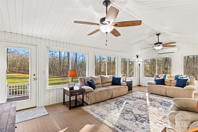 sunroom / solarium with vaulted ceiling, an AC wall unit, and ceiling fan