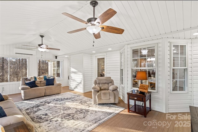 sunroom / solarium with lofted ceiling and a wall unit AC