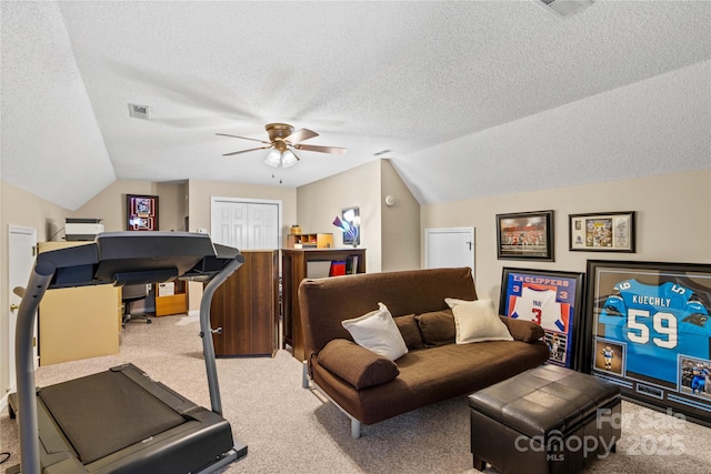 workout area with light carpet, ceiling fan, vaulted ceiling, and a textured ceiling